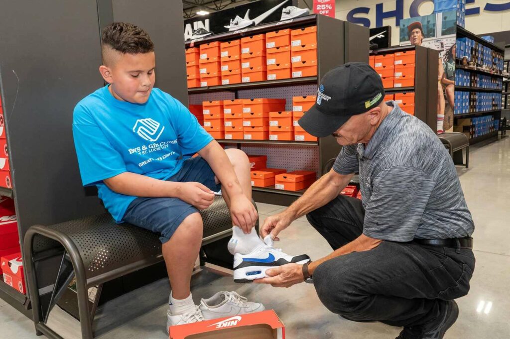 Academy-Shopping-Spree-boy trying on sneakers