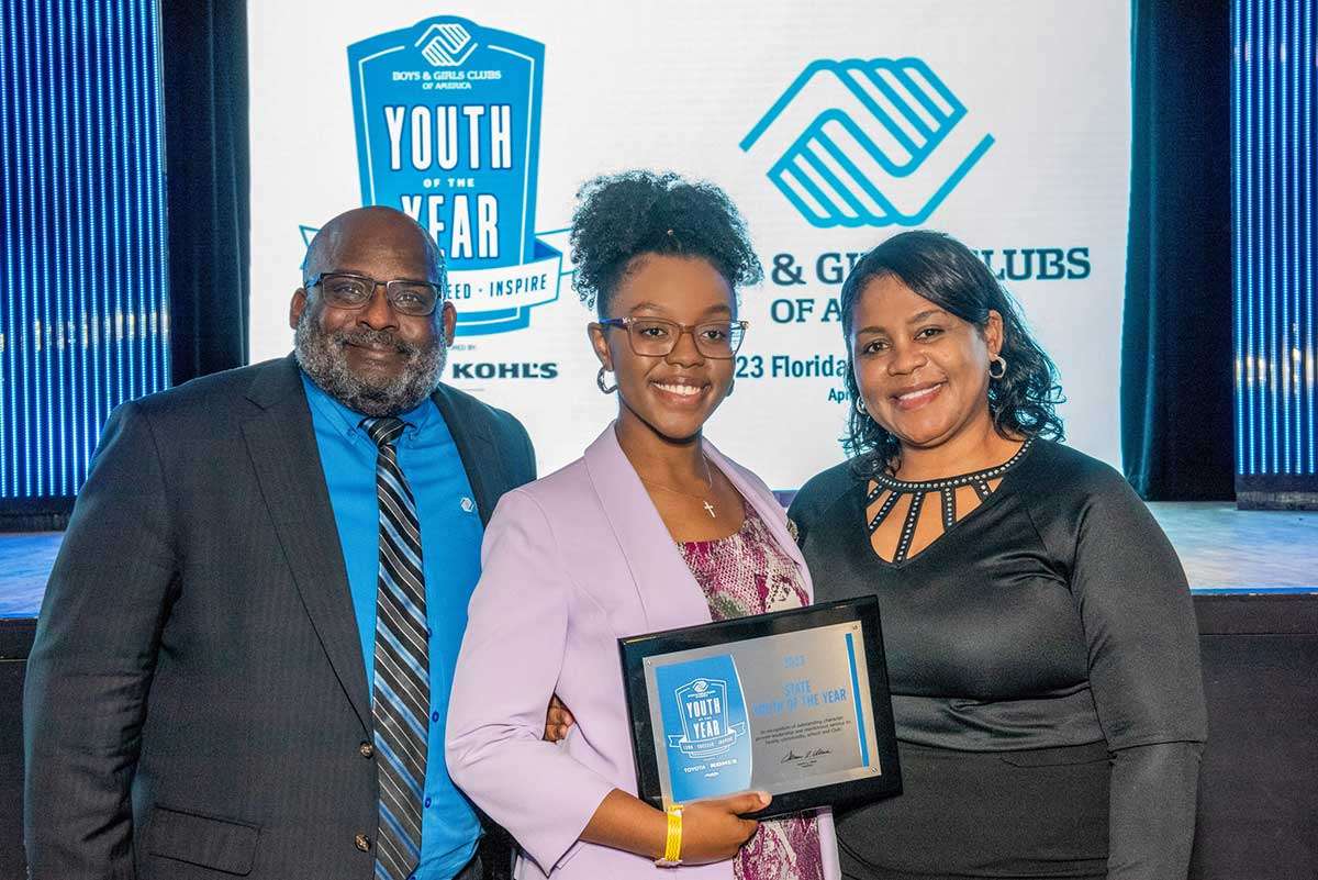 Mia holding State Youth of the Year with Will Armstead